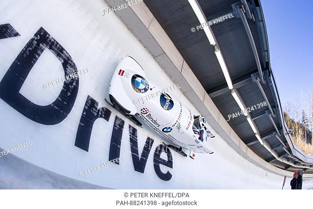 Bobsleigh athletes Oskars Kibermanis und Matiss Miknis from Latvia in the 3rd lap going through the echo curve in Schoenau am Koenigssee in Germany