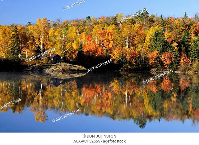 Autumn reflections in Bass Lake. Greater Sudbury, Ontario, Canada