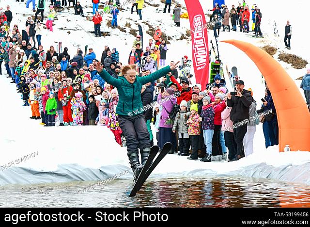 RUSSIA, IVANOVO REGION - APRIL 2, 2023: A skier lands in water during the 2023 edition of Easy-Freezy Festival at Milovka ski resort in the town of Plyos in...