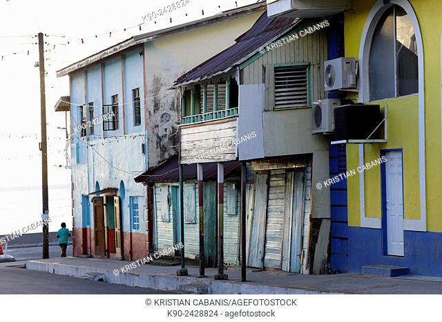 Streetscene with wooden houses in the center of Soufrière and a woman just turning around the corner, St Lucia, Windward Islands, Lesser Antilles