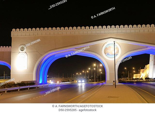 MUSCAT, OMAN Illuminated entrance gateway by road to the Muttrah and Sultan Qaboos port. Urban beautification