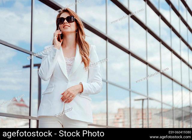 Businesswoman on cellphone running while talking on smart phone. Happy smiling caucasian business woman busy