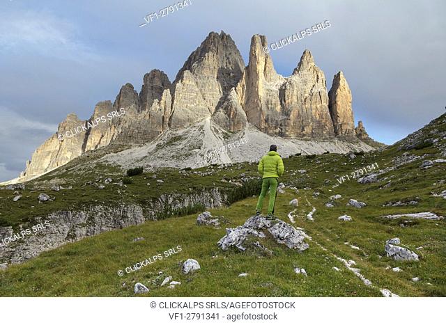 Europe, Italy, Veneto, Belluno. An hiker looking the Tre Cime di Lavaredo south side, Dolomites