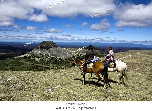 Trail riders traveling through the Itcha Mountains on horse in British Columbia Canada