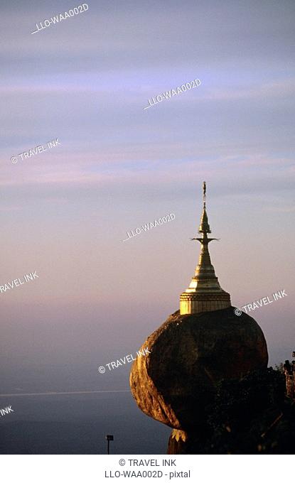 View of Kyaik-Tiyo Pagoda The Golden Rock at Sunset  Kyaikto, Myanmar, Asia