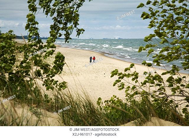 Beverly Shores, Indiana - Two women walk along the shore at Indiana Dunes National Lakeshore, at the southern end of Lake Michigan, on a chilly