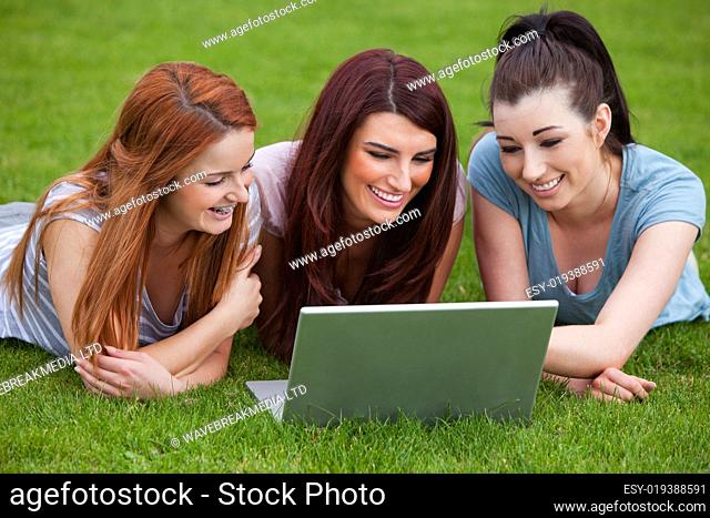 Smiling women using a notebook