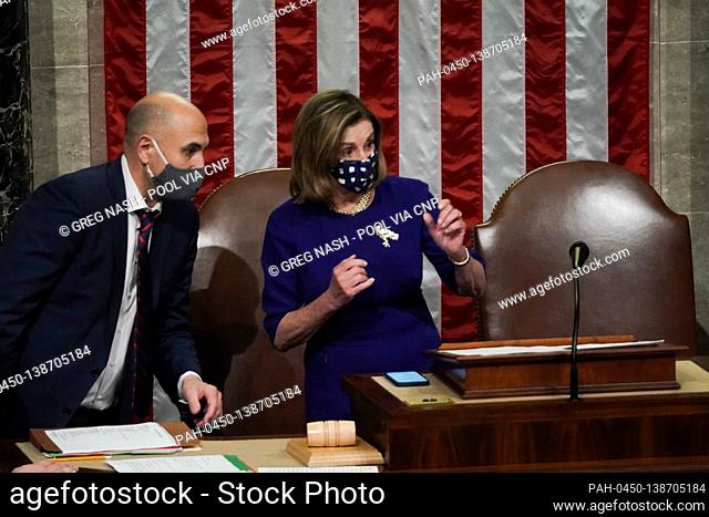 Speaker of the United States House of Representatives Nancy Pelosi (Democrat of California) speaks to aide as the House debates the certification of Arizona's...
