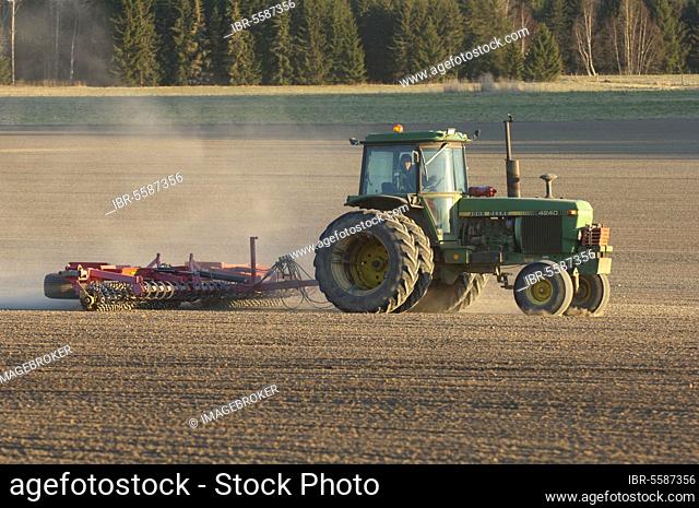 John Deere 4240 tractor with harrows, harrow field seedbed, Sweden, Europe