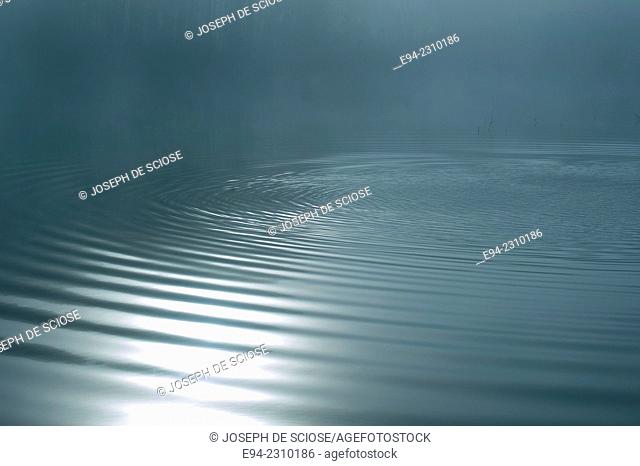 Horizontal photo of ripples on the water of a lake early in the morning, Alabama USA