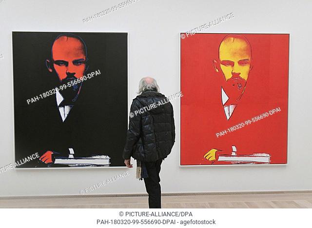 19 March 2018, Germany, Munich: A visitor standing in front of the pictures ""Lenin (black)"" and ""Lenin (red)"" by artist Andy at the opening of the...