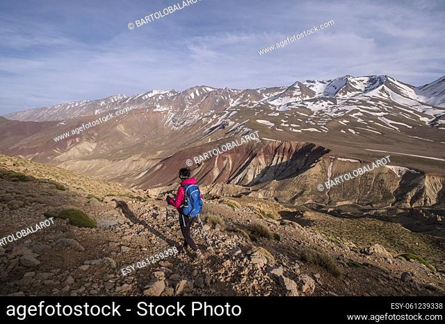 lonely woman . descending to the Tarkeddit plain, M Goun trek, Atlas mountain range, morocco, africa