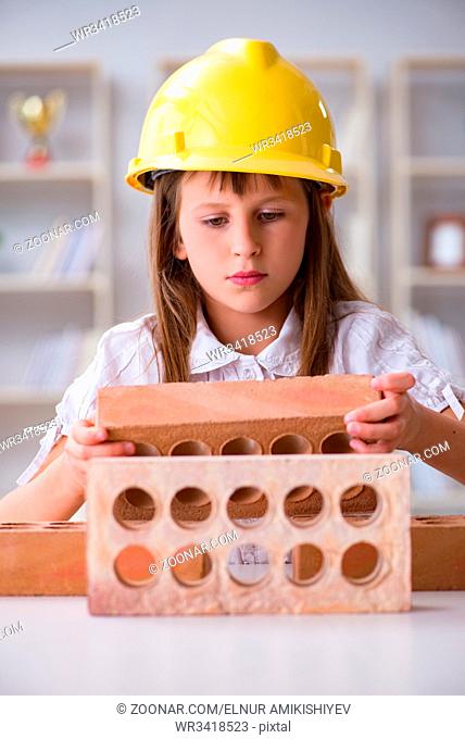 Small girl playing with bricks