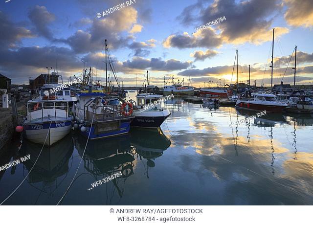 Boats in Padstow Harbour on the North Coast of Cornwall, capture shortly after sunrise on a still morning in January