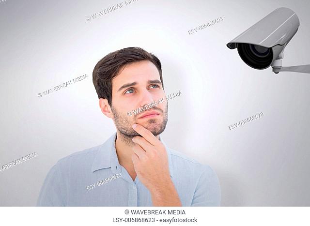 Composite image of serious thinking man looking up