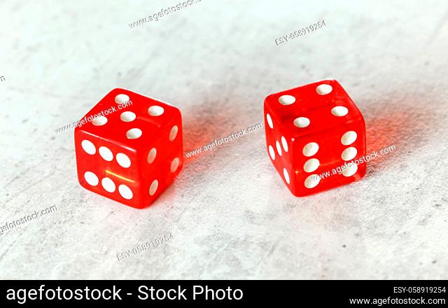 Two translucent red craps dices on white board showing Centerfield Nine Nina number 5 and 4