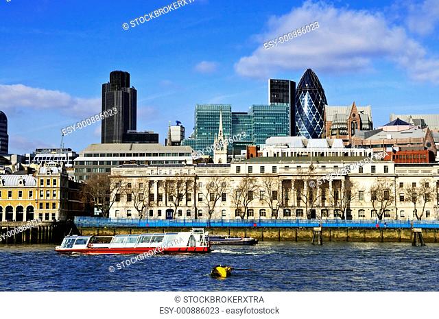 London skyline view from Thames river against blue sky