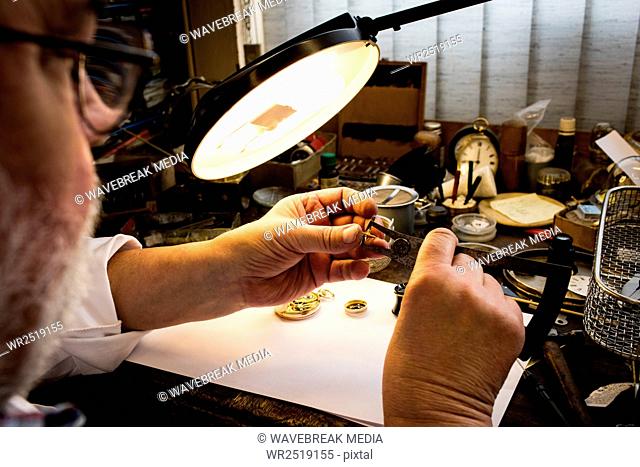 Close-up of horologist repairing a watch