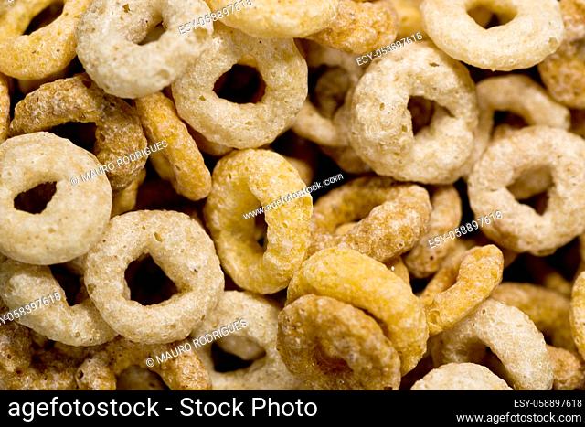 Close up view of many donut shaped cereals on a bowl