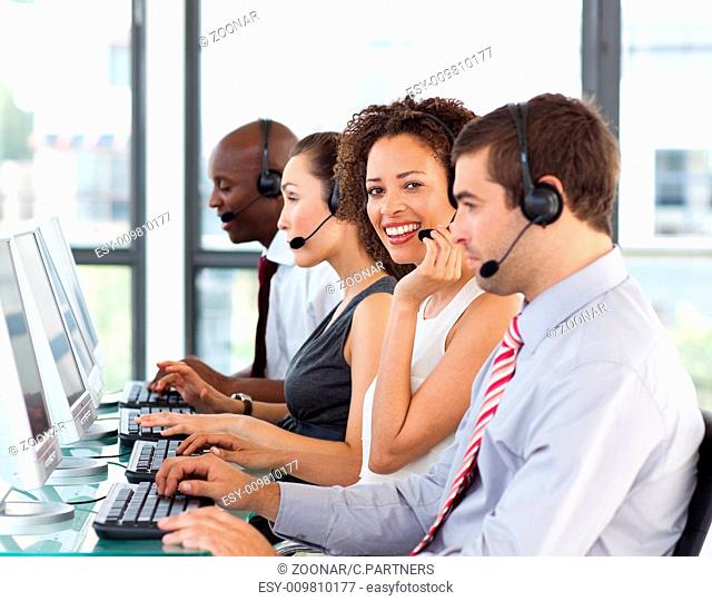 Smiling businesswoman working in a call center