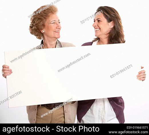 Friendly women holding blank board