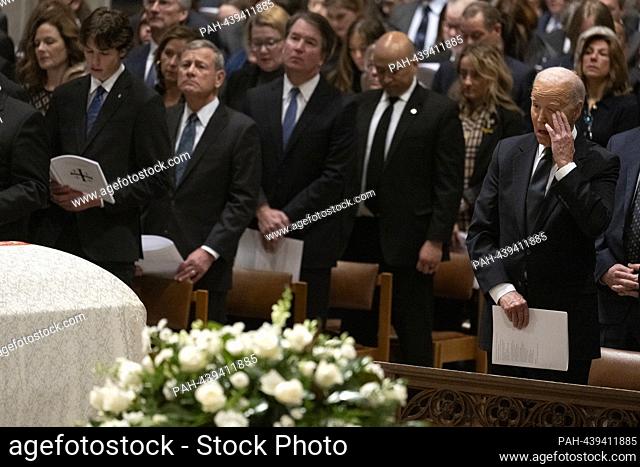 United States President Joe Biden (R) and Chief Justice of the United States John G. Roberts, Jr., second left, attend the memorial service for former Associate...