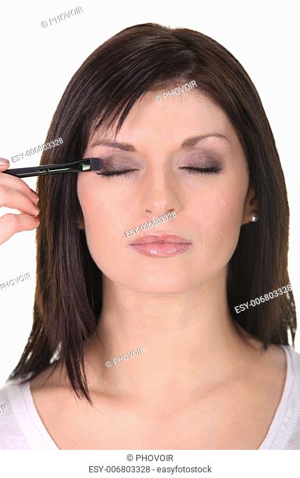 Woman applying eyeshadow