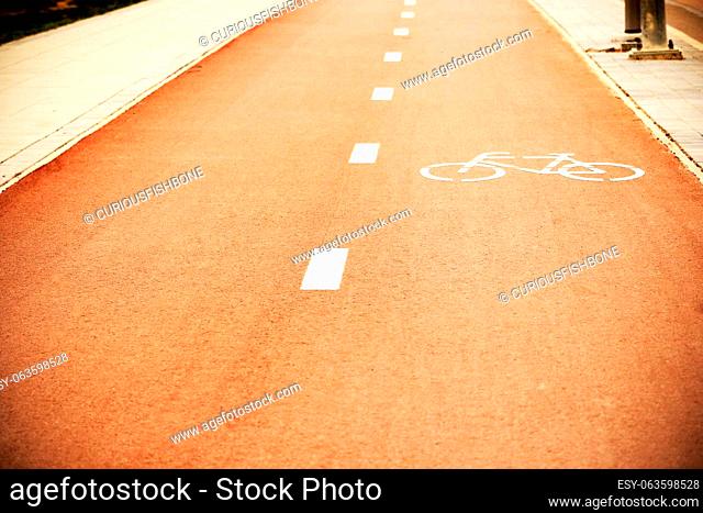 Downtown empty red bicycle track with painted marks