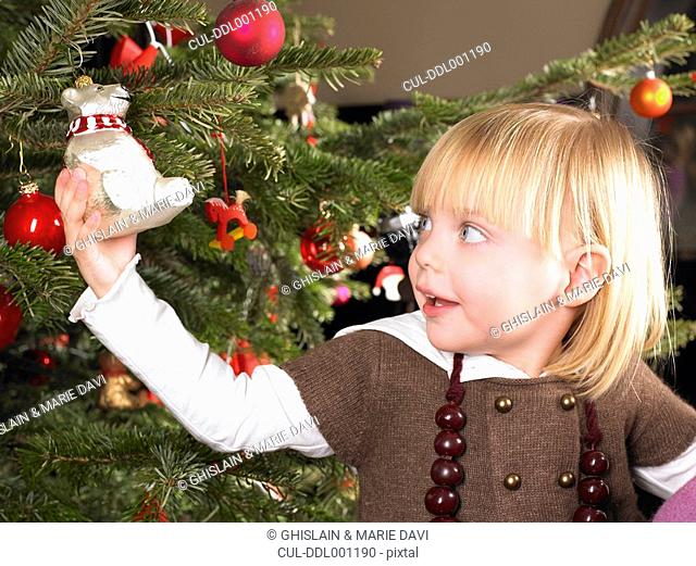 Girl playing with christmas decoration