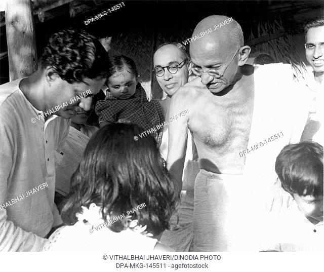 Mahatma Gandhi with Pyarelal Nayar b c and the leader of Nai Talim New Education Aryanaikam l , September 1944 NO MR