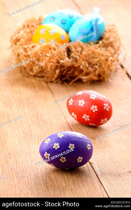 Nest with Easter eggs on the wooden table