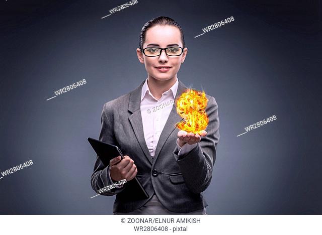 Businesswoman holding burning american dollar sign