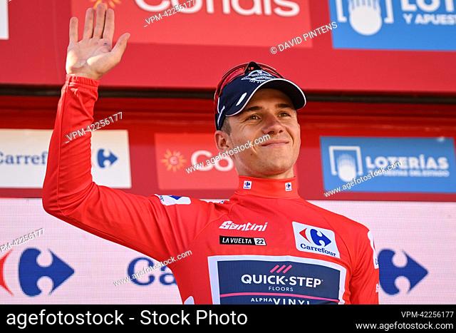 Belgian Remco Evenepoel of Quick-Step Alpha Vinyl celebrates on the podium in the red jersey for leader in the overall ranking after stage 13 of the 2022...