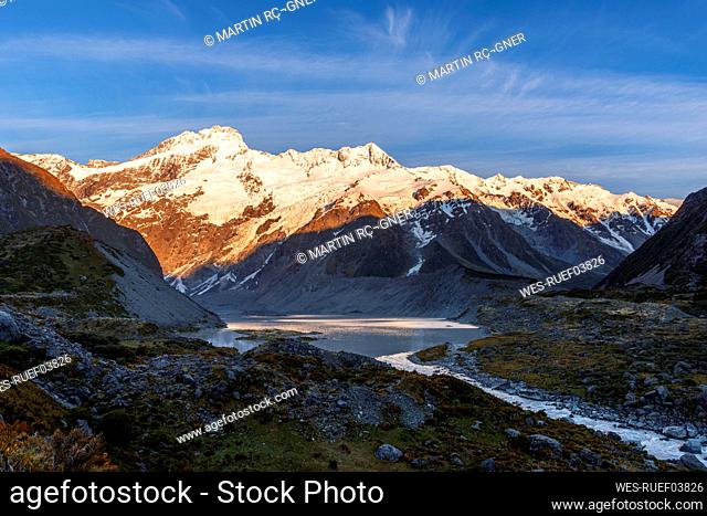 New Zealand, Canterbury Region, Hooker River and Mueller Lake at dawn with Mount Sefton in background
