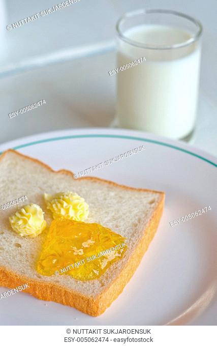 Bread butter jam on white plate