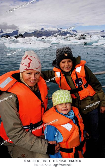 Woman and two children on a boat tour among icebergs, glacier, Joekulsarlon, Iceland, Europe