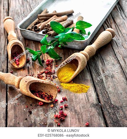 Set of different spices on the old wooden table.Photo rustic