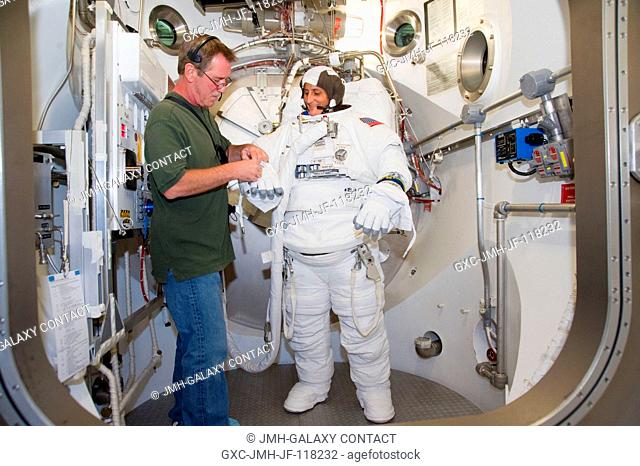 NASA astronaut Sunita Williams, Expedition 32 flight engineer and Expedition 33 commander, participates in an Extravehicular Mobility Unit (EMU) spacesuit fit...