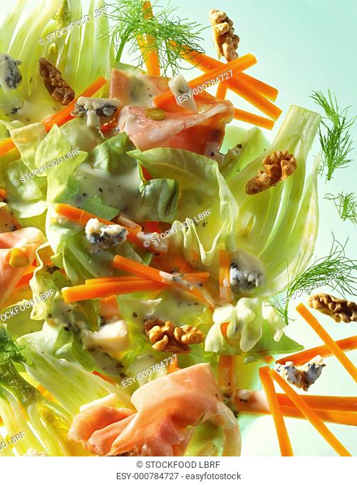 Lettuce with carrots, fennel, nuts, ham and cheese dressing