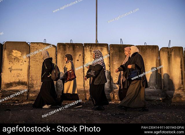 14 April 2023, Palestinian Territories, Qalandia: Palestinian worshippers pass the Qalandia checkpoint into Jerusalem to attend the fourth Friday prayer of the...