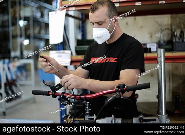 Workers at work in the new headquarters of Fantic Motor bicycle and mountain bike manufacturing company , Santa Maria di Sala (Venice), ITALY-28-09-2021