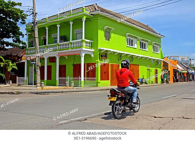 green painted building and motorcycle, Cartagena de Indias, Colombia