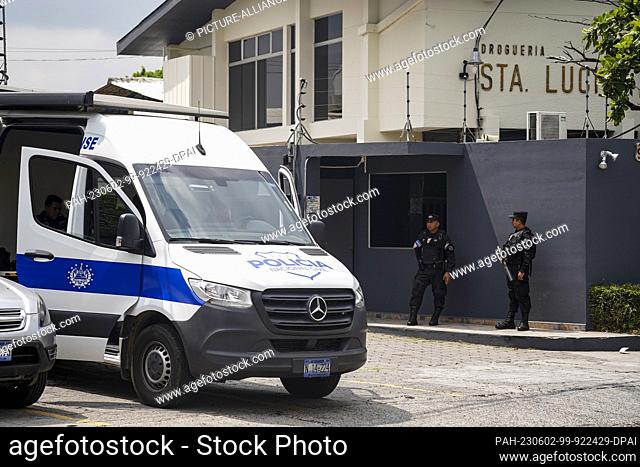 02 June 2023, El Salvador, San Salvador: Police officers are on duty at the ""Santa Lucia"" drugstore owned by ex-president Cristiani