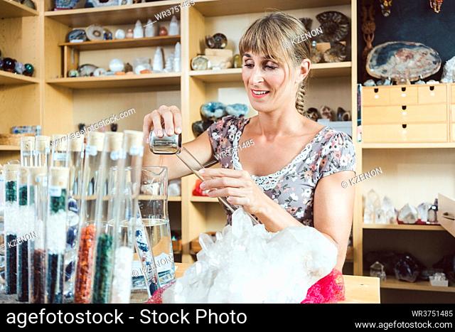 Young woman working with gemstones as a hobby in her workshop