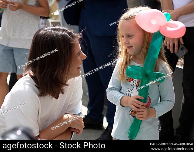 21 August 2022, Berlin: Foreign Minister Annalena Baerbock (Bündnis 90/Die Grünen) talks to a child at the Federal Government's Open Day at the Federal Foreign...