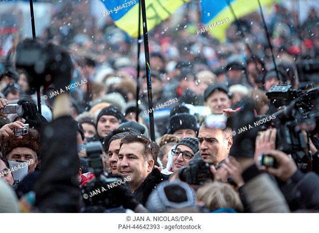 Opposition supporters continue their protest as former president Mikheil Saakashvili (3rd from L) pushes through the crowd to talk to the demonstrators on the...