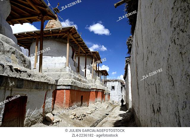 Silhouette of a man in a street with stupa (chorten) in the walled city of Lo Manthang, the historical capital of the Kingdom of Lo