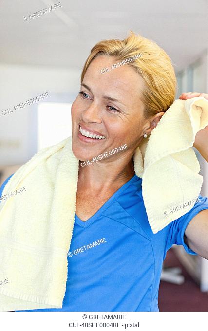 Woman toweling off in gym