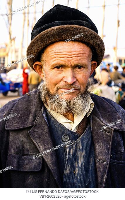 portrait of Uyghur man in Kashgar Sunday market , Xinjiang , China