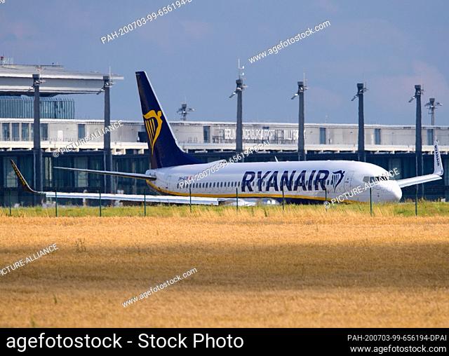 02 July 2020, Brandenburg, Schönefeld: A Boeing 737-800 Winglets of the airline Ryanair turns after its flight from Thessaloniki behind a grain field on the...